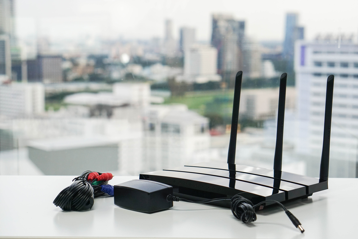 black Wifi router with charger in office